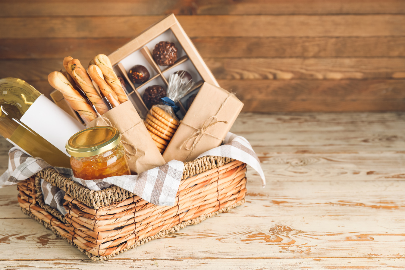 Gift Basket with Products on Wooden Background